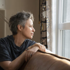Woman looking out the window at home
