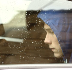 Sad teenager boy worried inside a car